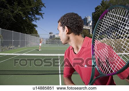 Couple playing tennis; Canada, British Columbia, Vancouver View Large Photo Image Stock Image - Couple playing tennis; Canada, British Columbia, Vancouver. Fotosearch