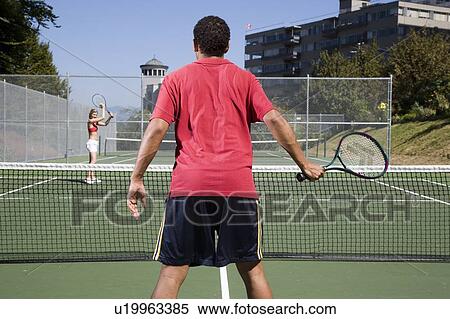 Stock Photography - Couple playing tennis; Canada, British Columbia, Vancouver. Fotosearch