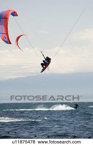 Stock Photo - Kiteboarder jumping, Victoria, BC. Fotosearch