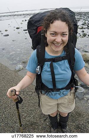 Stock Photography - Smiling Woman (20-25) on a beach with a large backpack on, West Coast Trail, Pacific Rim National Park Reserve, BC. Fotosearch