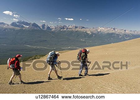 Three hikers in the alpine on a ridge, Skyline Trail, Jasper National Park, Alberta, Canada View Large Photo Image Picture - Three hikers in the alpine on a ridge, Skyline Trail, Jasper National Park, Alberta, Canada. Fotosearch