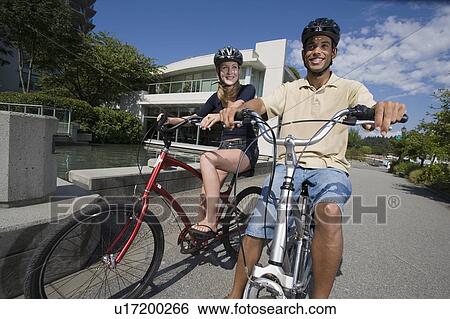 Young Couple Ride Bicycles on city bike path, Vancouver, British Columbia View Large Photo Image Stock Photograph - Young Couple Ride Bicycles on city bike path, Vancouver, British Columbia. Fotosearch