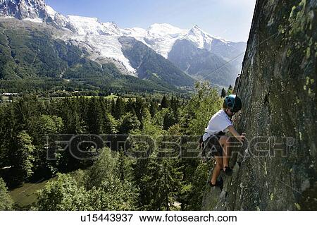 Stock Photo - Young kid climbing in front of Mont Blanc, Les Gaillands, Chamonix. Fotosearch