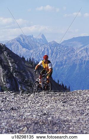 Stock Photography - young man mountain biking at Fernie Alpine Resort, Fernie, BC, Canada. Fotosearch