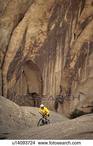 young man mountain biking on Slickrock Trail near Moab, Utah, USA View Large Photo Image Picture - young man mountain biking on Slickrock Trail near Moab, Utah, USA. Fotosearch