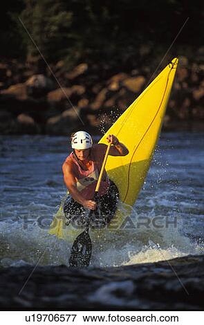 Stock Photo - young man performs ender in c-1 canoe on the Ottawa river, Ontario, Canada. Fotosearch