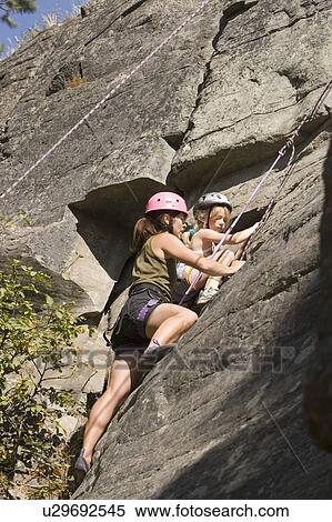 Young woman climbing with daughter (age 7) up granite cliff at Stone Hills near Rexford, Montana, USA View Large Photo Image Stock Photography - Young woman climbing with daughter (age 7) up granite cliff at Stone Hills near Rexford, Montana, USA. Fotosearch