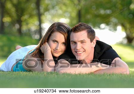 Boy and girl teenagers in grass at park, Regina, Saskatchewan View Large Photo Image Picture - Boy and girl teenagers in grass at park, Regina, Saskatchewan. Fotosearch