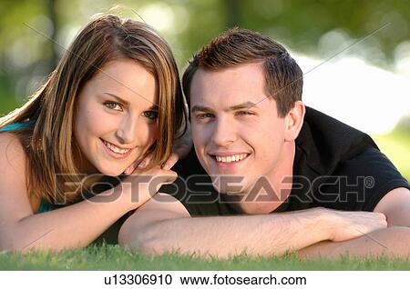Boy and girl teenagers in grass at park, Regina, Saskatchewan View Large Photo Image Stock Image - Boy and girl teenagers in grass at park, Regina, Saskatchewan. Fotosearch