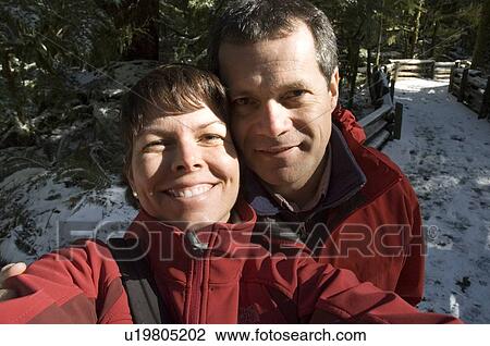 Stock Image - Couple enjoys old growth forest in Cathedral Grove in MacMillan Provincial Park, near Port Alberni, Vancouver Island, BC. Fotosearch