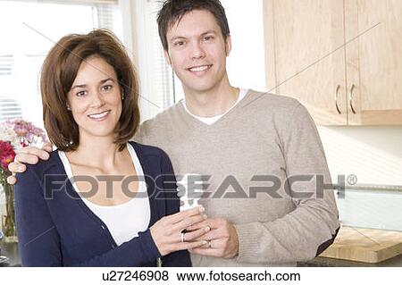 Couple holding energy efficient compact flourescent bulb, Winnipeg, Canada View Large Photo Image Stock Photo - Couple holding energy efficient compact flourescent bulb, Winnipeg, Canada. Fotosearch