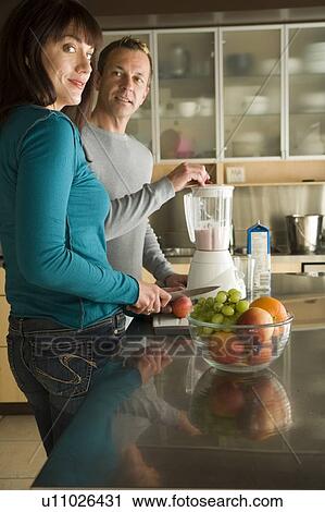 Couple making fruit smoothies with organic fruit, Winnipeg, Canada. View Large Photo Image Stock Image - Couple making fruit smoothies with organic fruit, Winnipeg, Canada. . Fotosearch