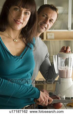 Couple making fruit smoothies with organic fruit, Winnipeg, Canada. View Large Photo Image Stock Image - Couple making fruit smoothies with organic fruit, Winnipeg, Canada. . Fotosearch