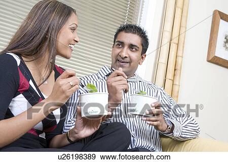 Couple on sofa eating from corn-based, fully compostable, take-out containers, Winnipeg, Canada View Large Photo Image Stock Photo - Couple on sofa eating from corn-based, fully compostable, take-out containers, Winnipeg, Canada. Fotosearch