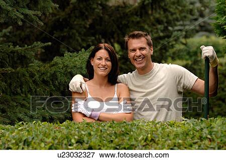 Couple posing behind hedge, Regina, Saskatchewan View Large Photo Image Stock Photo - Couple posing behind hedge, Regina, Saskatchewan. Fotosearch