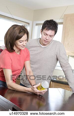 Couple reading nutritional information labelling on can, Winnipeg, Canada View Large Photo Image Stock Photo - Couple reading nutritional information labelling on can, Winnipeg, Canada. Fotosearch