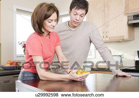 Couple reading nutritional information labelling on can, Winnipeg, Canada View Large Photo Image Stock Photo - Couple reading nutritional information labelling on can, Winnipeg, Canada. Fotosearch