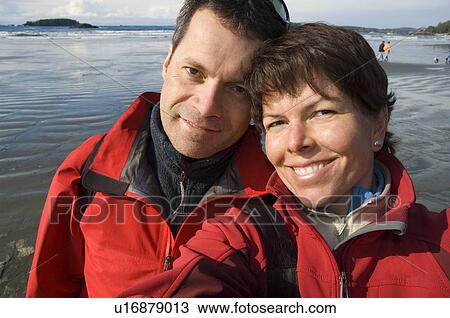 Couple self portrait on beach, Chesterman Beach, Tofino, Vancouver Island, BC View Large Photo Image Stock Image - Couple self portrait on beach, Chesterman Beach, Tofino, Vancouver Island, BC. Fotosearch