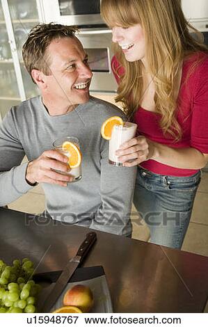 Stock Photo - Couple with fruit smoothie made with organic fruit, Winnipeg, Canada. Fotosearch