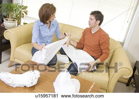 Stock Image - Man and woman folding cloth diapers, Winnipeg, Canada. Fotosearch