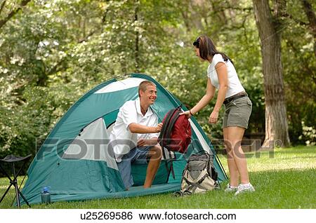 Young couple in front of tent w/ red backpack, Regina, Saskatchewan View Large Photo Image Stock Photograph - Young couple in front of tent w/ red backpack, Regina, Saskatchewan. Fotosearch