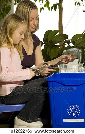 Stock Photography - Mother and daughter recycling. Fotosearch