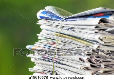 Newspapers tied into a pile for the recycle bin. View Large Photo Image Stock Photo - Newspapers tied into a pile for the recycle bin.. Fotosearch
