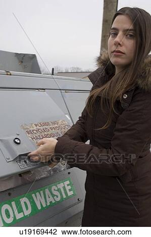 Stock Image - Woman recycling; Canada, Ontario. Fotosearch