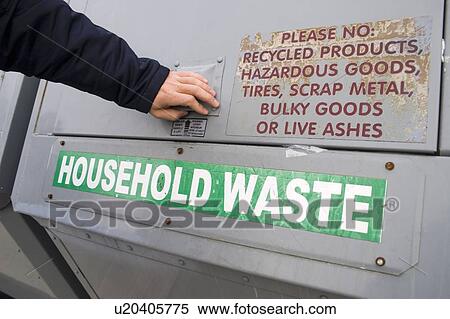 Stock Photography - Woman recycling; Canada, Ontario. Fotosearch