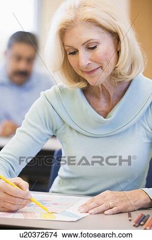 Picture - Adult student in class drawing picture (selective focus). Fotosearch