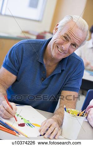 Stock Photograph - Adult student in class drawing picture. Fotosearch