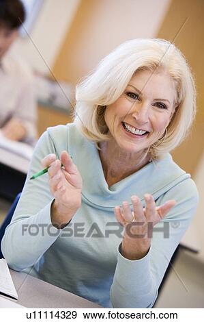 Adult student in class smiling (selective focus) View Large Photo Image Stock Photo - Adult student in class smiling (selective focus). Fotosearch