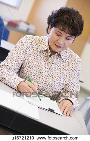 Adult student in class taking notes View Large Photo Image Stock Image - Adult student in class taking notes. Fotosearch