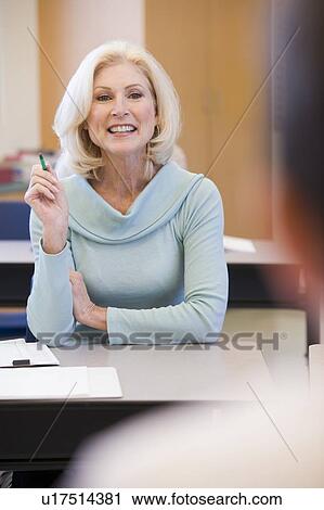 Adult student in class with teacher (selective focus) View Large Photo Image Stock Image - Adult student in class with teacher (selective focus). Fotosearch