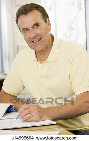 Adult student studying at table View Large Photo Image Picture - Adult student studying at table. Fotosearch