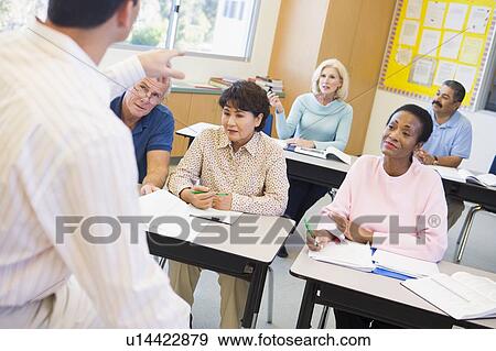Adult students in class with teacher (selective focus) View Large Photo Image Stock Photo - Adult students in class with teacher (selective focus). Fotosearch