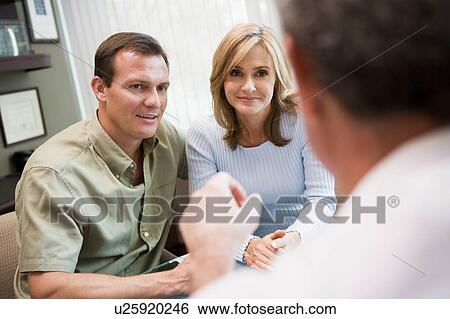 Stock Photograph - Couple in consultation at IVF clinic (selective focus). Fotosearch