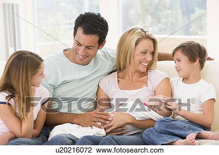 Family in living room with baby smiling View Large Photo Image Stock Image - Family in living room with baby smiling. Fotosearch