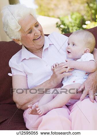 Grandmother outdoors on patio with baby smiling View Large Photo Image Stock Photography - Grandmother outdoors on patio with baby smiling. Fotosearch