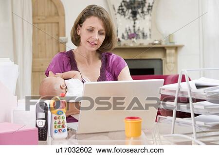 Mother and baby in home office with laptop View Large Photo Image Stock Image - Mother and baby in home office with laptop. Fotosearch