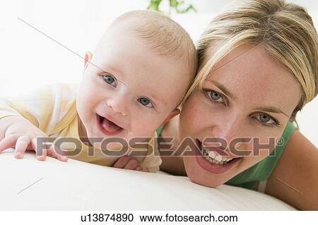 Mother and baby indoors smiling View Large Photo Image Stock Image - Mother and baby indoors smiling. Fotosearch
