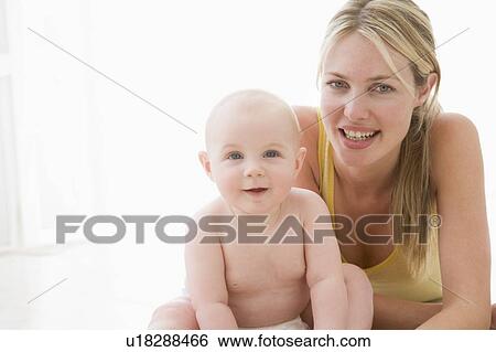 Mother and baby indoors smiling View Large Photo Image Stock Photograph - Mother and baby indoors smiling. Fotosearch