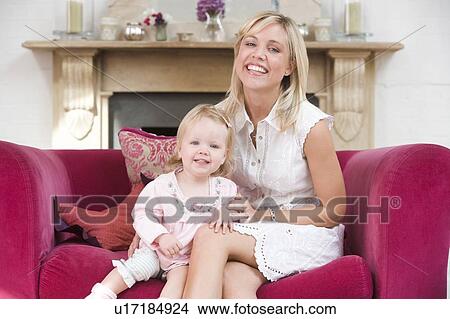 Mother in living room with baby smiling View Large Photo Image Picture - Mother in living room with baby smiling. Fotosearch