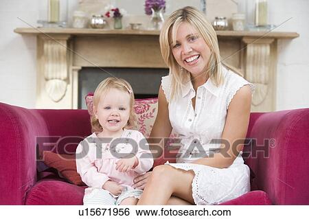 Stock Photograph - Mother in living room with baby smiling. Fotosearch