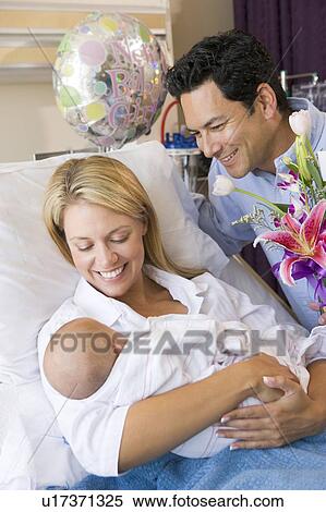 New mother with baby and husband in hospital smiling View Large Photo Image Stock Photography - New mother with baby and husband in hospital smiling. Fotosearch