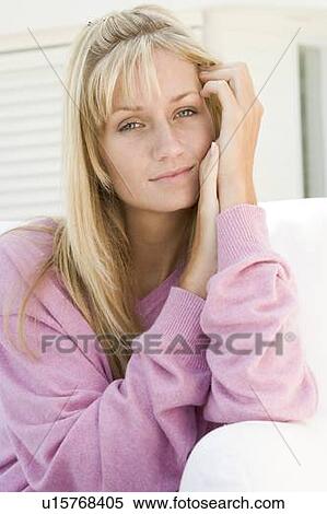 Blonde woman in a pink sweater posing outdoors View Large Photo Image Stock Photography - Blonde woman in a pink sweater posing outdoors. Fotosearch