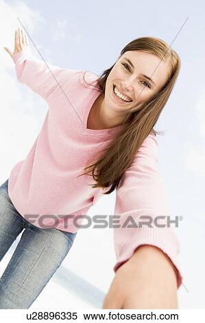 Stock Photography - Woman in a pink sweater posing. Fotosearch