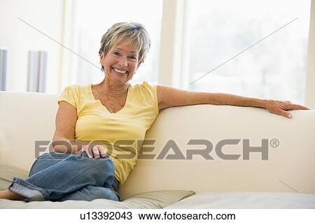 Woman in living room smiling View Large Photo Image Stock Image - Woman in living room smiling. Fotosearch