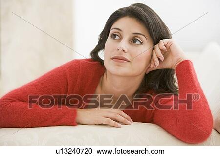 Woman sitting in living room View Large Photo Image Stock Image - Woman sitting in living room. Fotosearch