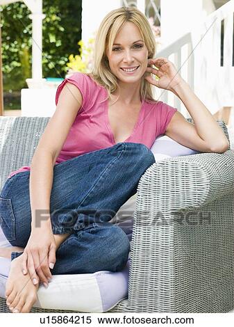 Woman sitting outdoors on patio smiling View Large Photo Image Stock Photography - Woman sitting outdoors on patio smiling. Fotosearch